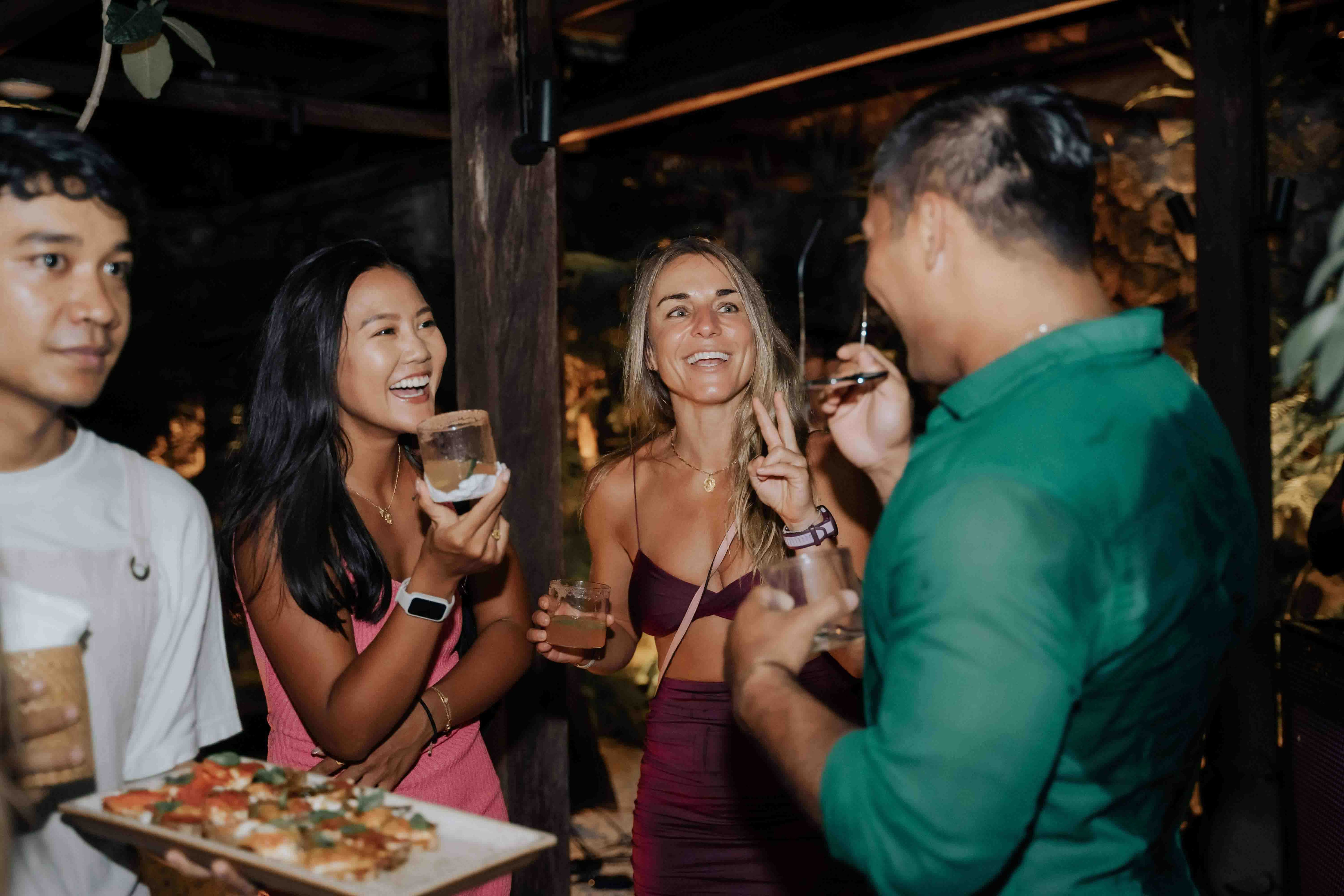 Guests enjoying drinks and appetisers at Wrong Gym Bali's Charity Night event, with vibrant conversations and lively atmosphere.