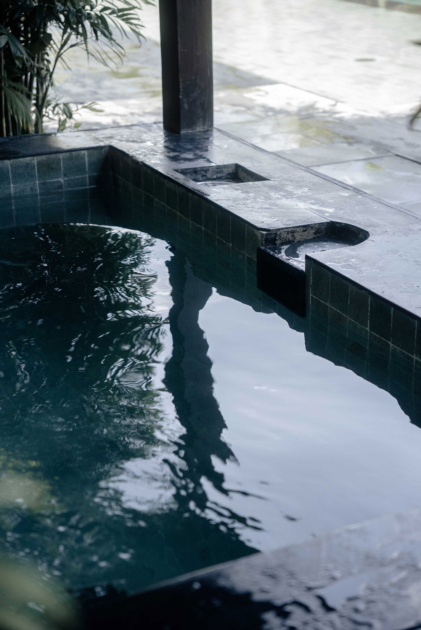 Tranquil tiled ice bath at Wrong Gym Bali, designed for post-training recovery and cold therapy, surrounded by lush tropical greenery.