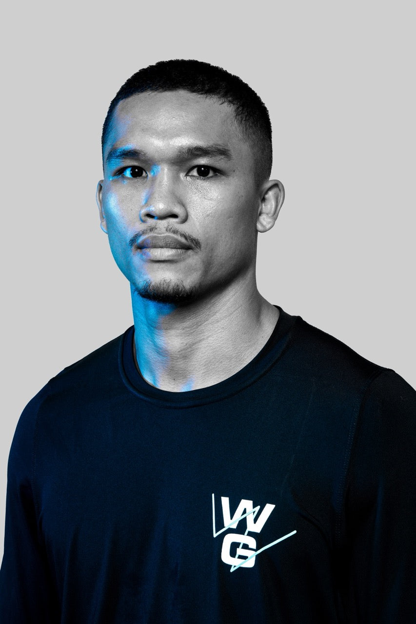 Close-up portrait of Wrong Gym Bali coach Cakti wearing branded training apparel with a confident, focused look.