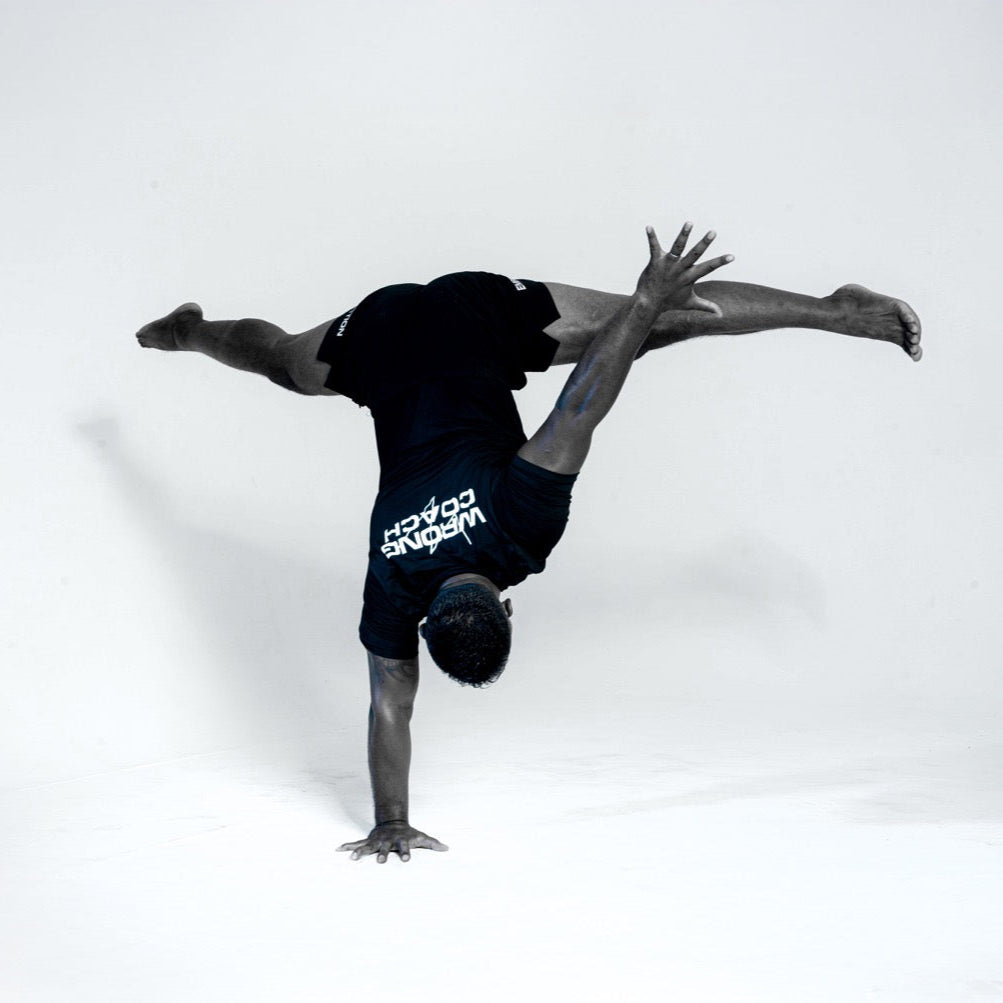 Wrong Gym Bali coach performing advanced one-arm handstand to demonstrate mobility and control.