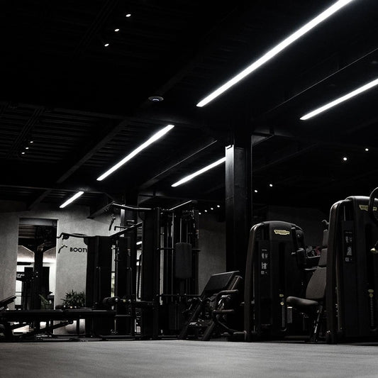 Modern gym interior with black walls and lighting
