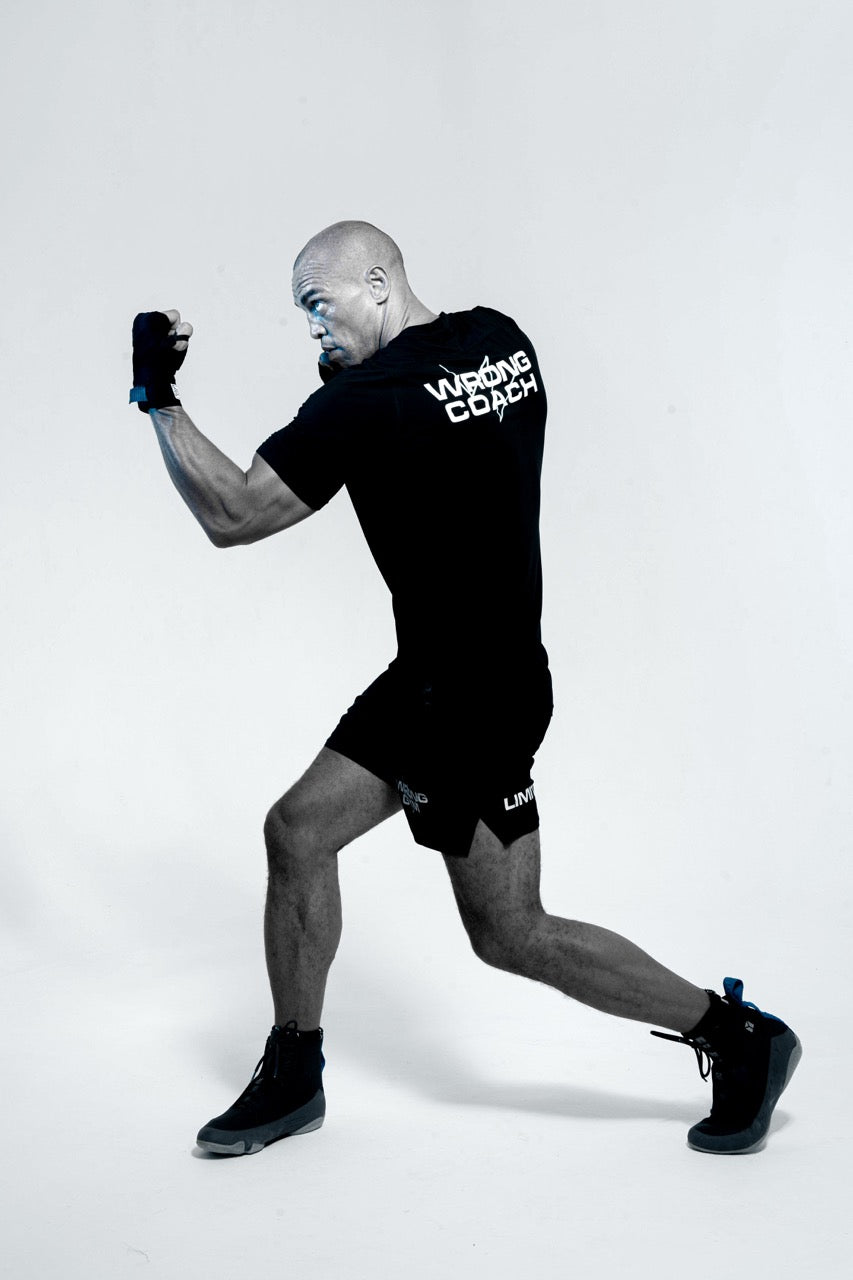 Wrong Gym Bali boxing coach Simon posing in a fighting stance wearing branded training gear.